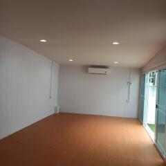 Spacious living room with air conditioning and sliding glass doors