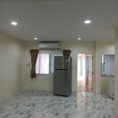 Kitchen with refrigerator and marble floor