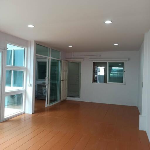 Spacious living area with large windows and glass doors