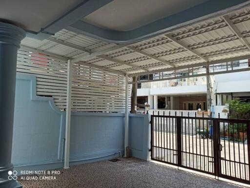 Covered garage area with gate and tiled floor