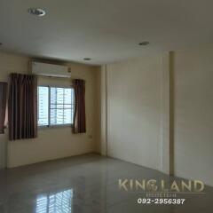 Vacant living area with a window, air conditioner, and tiled flooring