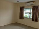 Bedroom with window and air conditioning