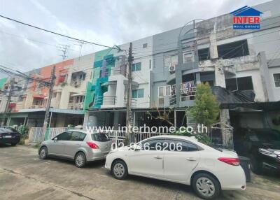 Front view of residential buildings with parked cars