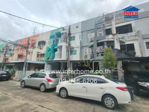 Front view of residential buildings with parked cars