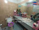 Bathroom with tiled walls, single vanity, and decorated surfaces