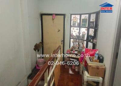 Hallway with storage items and a decorative door