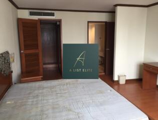 Bedroom with wooden flooring and basic furnishings