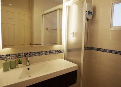 Modern bathroom with sink, shower, and decorative tiles