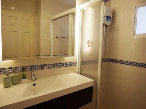 Modern bathroom with sink, shower, and decorative tiles