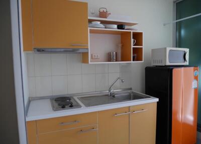 Modern kitchen with orange cabinets and appliances