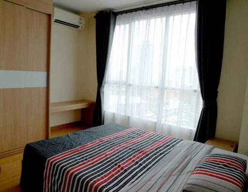 Modern bedroom with striped bedspread