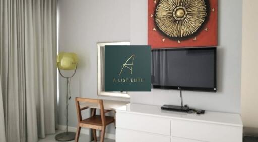 Modern bedroom with TV, desk, and chair