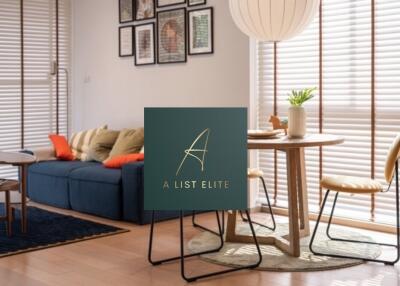 A modern living area with a blue sofa and a round dining table