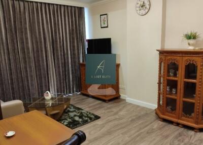 Spacious living room with wooden furniture and a TV