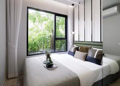 Modern bedroom with large window and greenery view