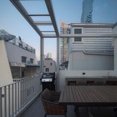 Outdoor terrace with dining table and barbecue