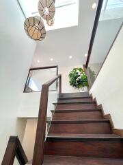 Modern staircase with wooden steps and glass railings