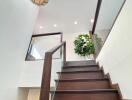 Modern staircase with wooden steps and glass railings