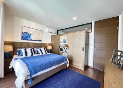 Spacious and modern bedroom with double bed and ample storage