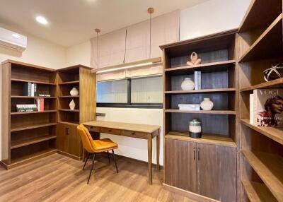 Modern home office with built-in wooden shelves and desk