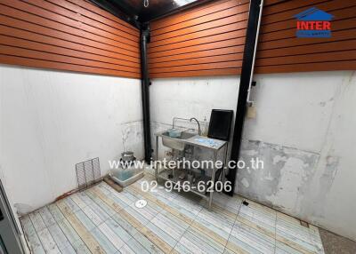 Covered patio area with sink and wooden slat ceiling