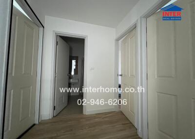 Hallway with doors and bathroom entrance