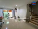 Living room with stairs and sliding door to balcony