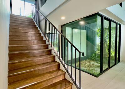 Staircase and glass-walled interior garden