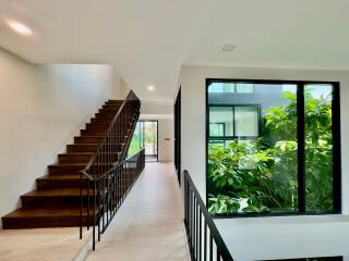 Staircase and hallway with large window