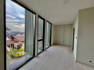 Modern room with large windows and a view of the neighborhood