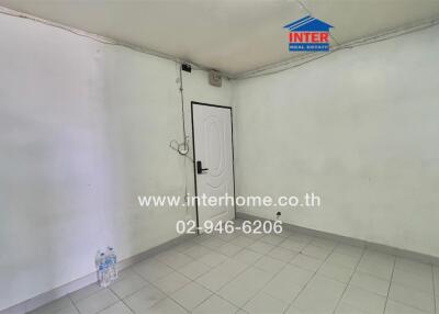 Empty room with tiled floor and white walls