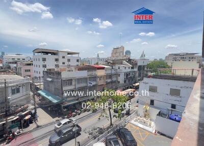 View of a city from a building with several multi-story buildings and traffic on the streets