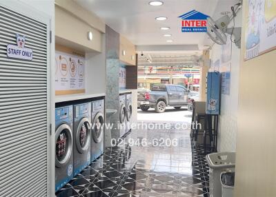 Modern laundry room with multiple washing machines and dryers