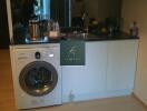 A compact kitchen with sink and washing machine