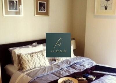 Bedroom with decorative bedspread and wall art