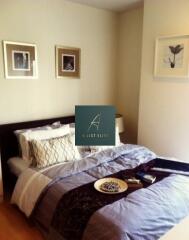 Bedroom with decorative bedspread and wall art