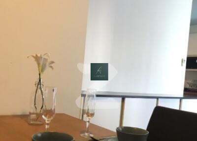 Dining table with place settings and vase with flowers