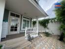 Front entrance of the house with porch and a tiled walkway