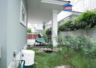 Outdoor area with lush greenery and a water pump