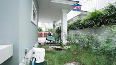 Outdoor area with lush greenery and a water pump