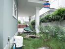 Outdoor area with lush greenery and a water pump