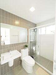 Modern bathroom with walk-in shower and tile wall