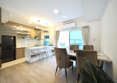 Modern kitchen and dining area with marble countertops and stylish furniture