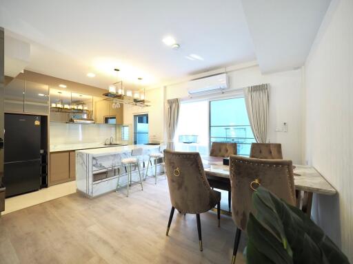 Modern kitchen and dining area with marble countertops and stylish furniture