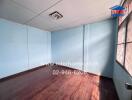 Bedroom with wooden floor and blue walls