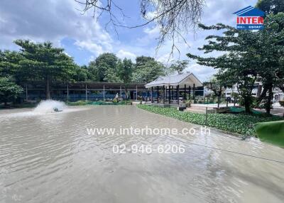 Serene outdoor area with a pond and pavilion