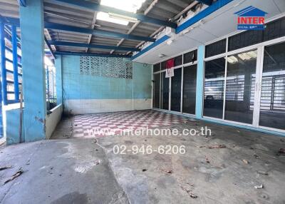 Open area with concrete floor and tiled section