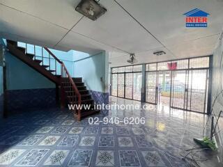 Spacious living area with stairs and large windows