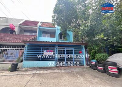 Two-story residential building with a blue facade