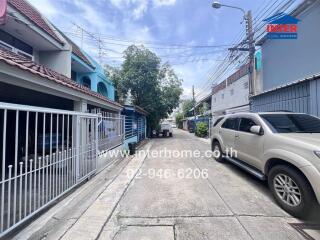 Residential street with houses and parked cars